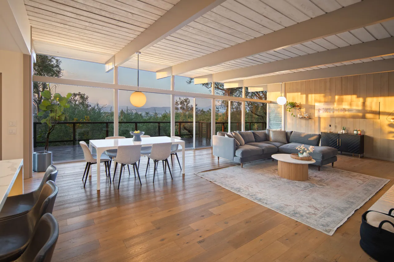 The great room at golden hour, dining and living areas together