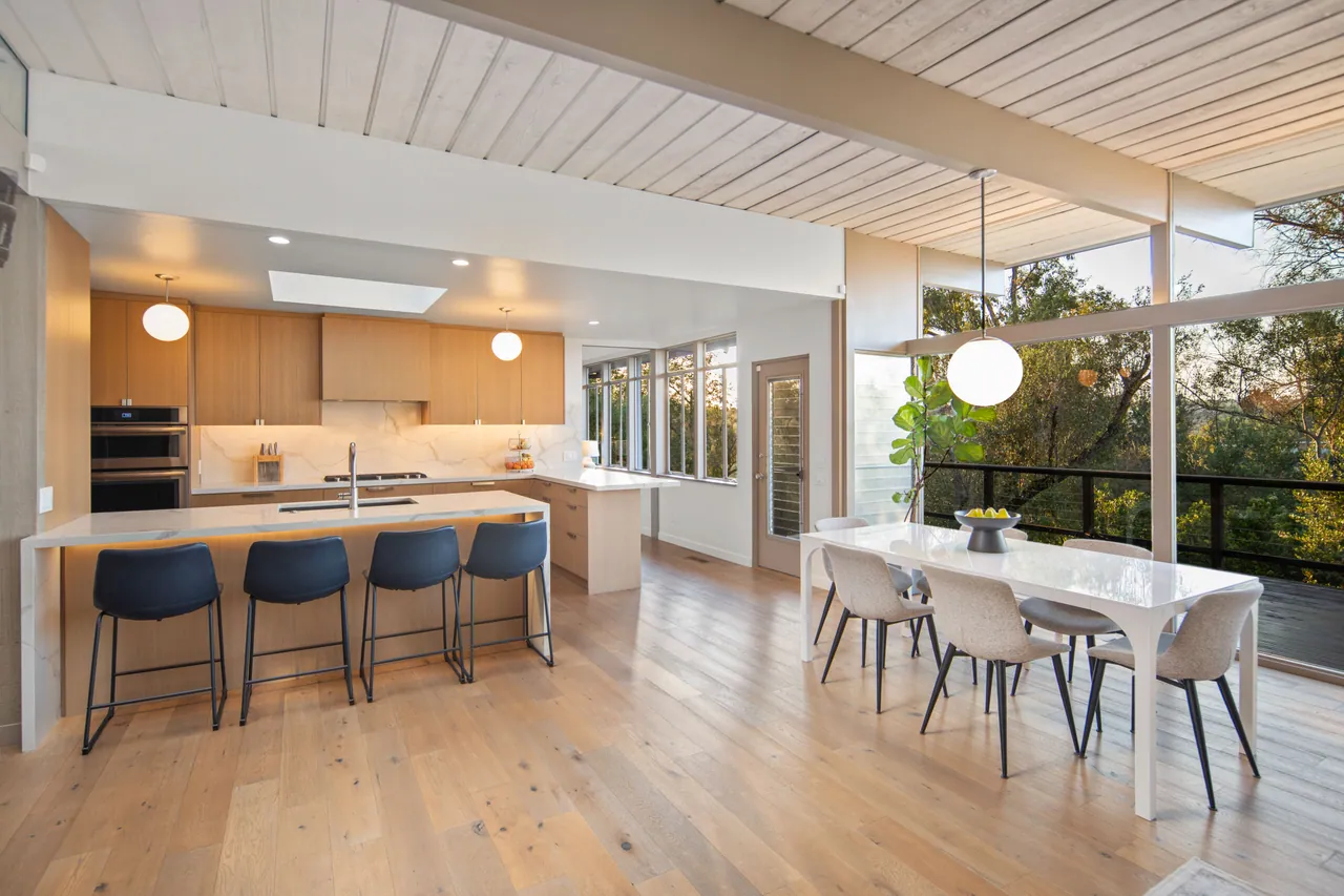 Kitchen island with seating, oak cabinetry and skylight