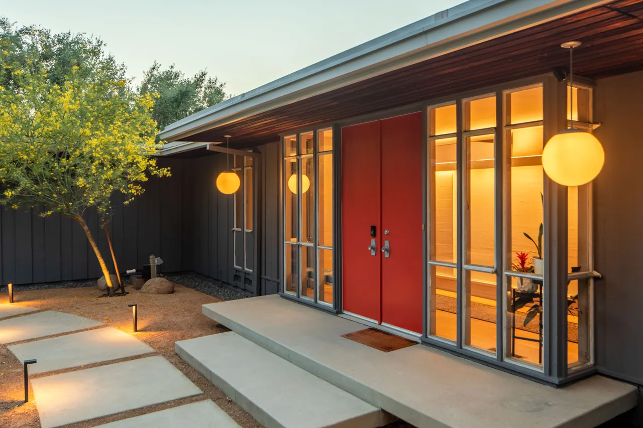 Vermilion front doors and globe pendants at twilight